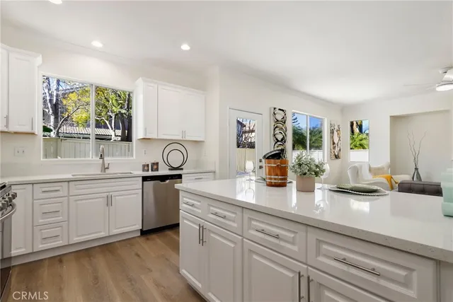 a kitchen with sink stove and cabinets