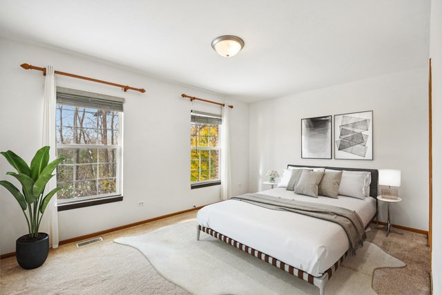 1524 Anderson Trail Zion, IL 60099 - Photo 11 of 22 a bedroom with a large bed and a potted plant