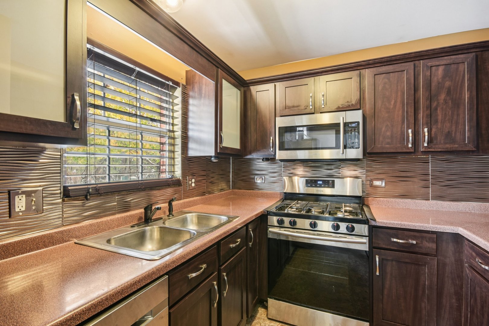 1524 Anderson Trail Zion, IL 60099 - Photo 6 of 22 a kitchen with granite countertop a sink stainless steel appliances and cabinets