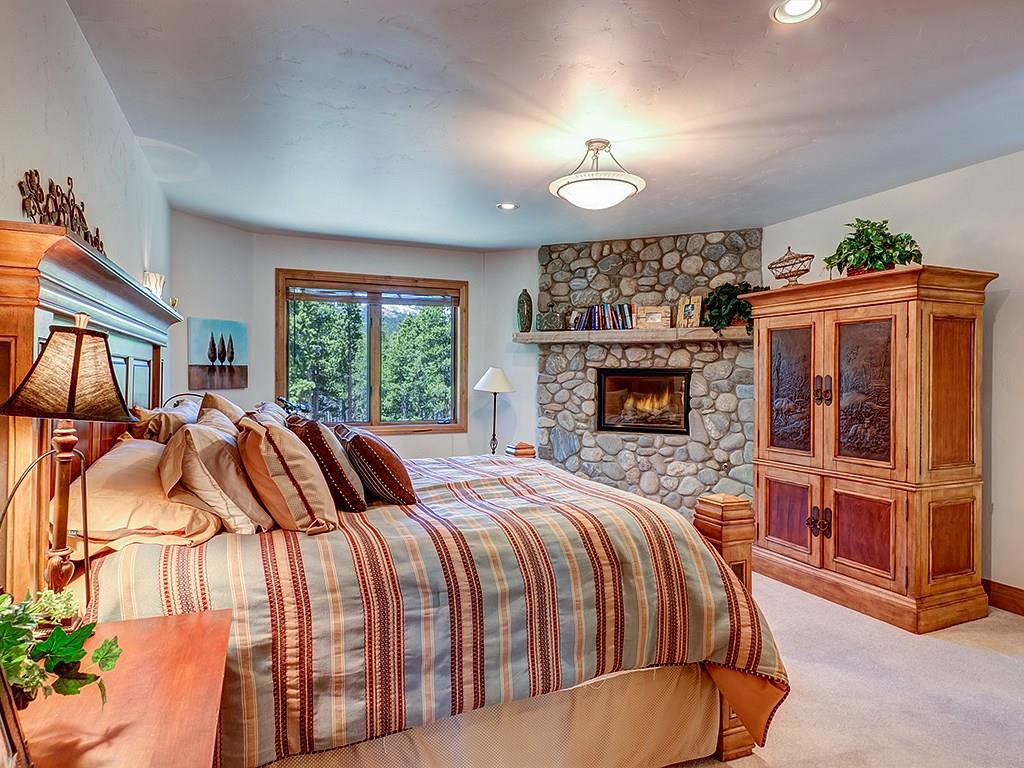 677 White Cloud Drive Breckenridge, CO 80424 - Photo 14 of 25 a bedroom with a bed and a fireplace