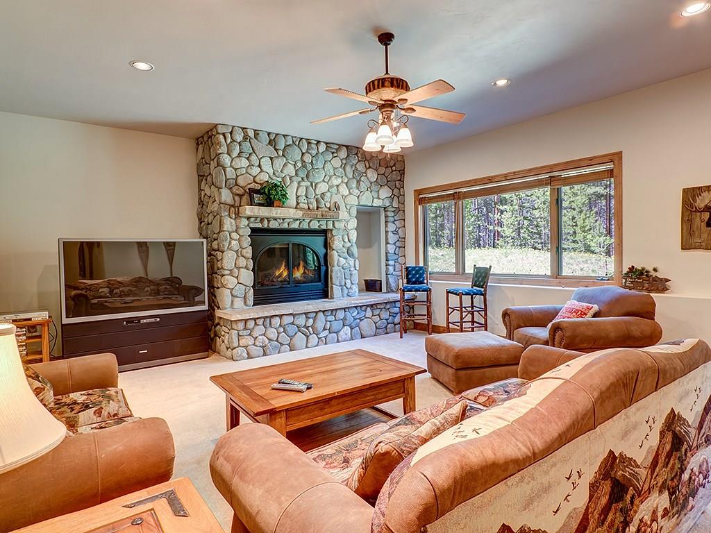 677 White Cloud Drive Breckenridge, CO 80424 - Photo 18 of 25 a living room with furniture fireplace and a large window