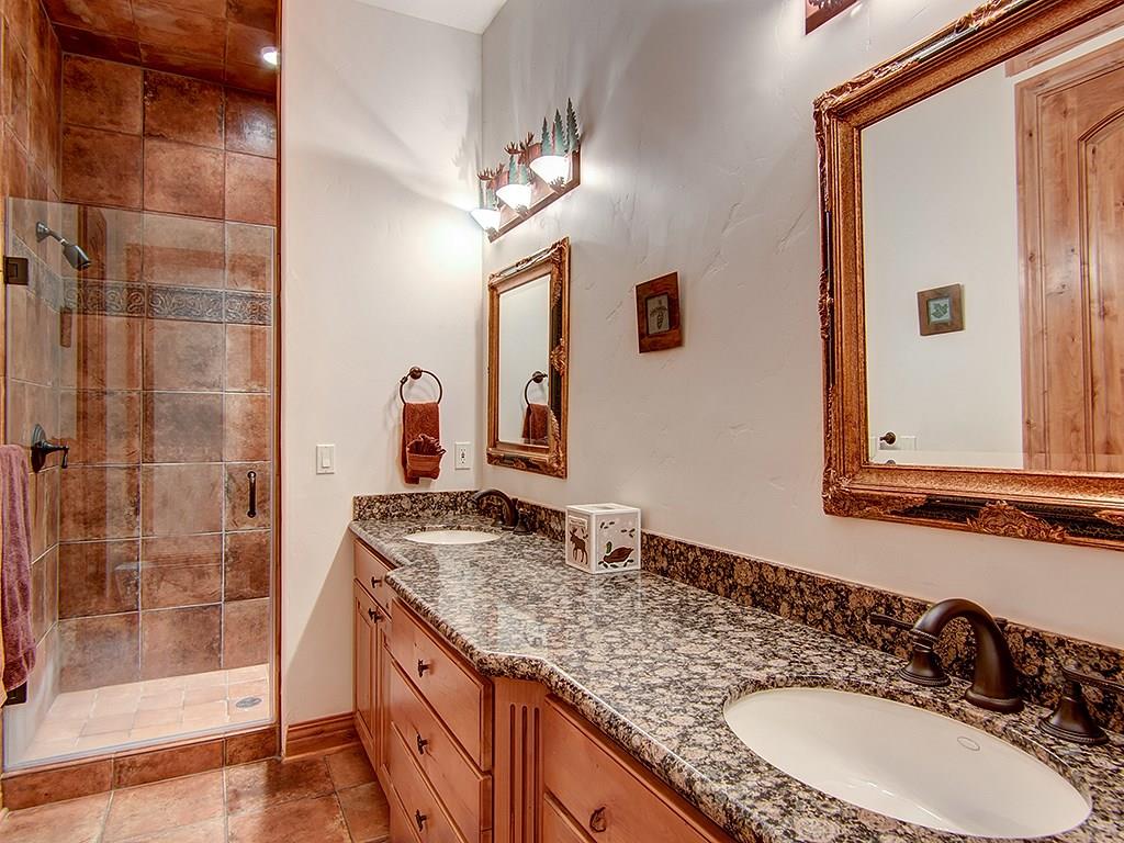 677 White Cloud Drive Breckenridge, CO 80424 - Photo 22 of 25 a bathroom with a granite countertop sink a mirror and shower