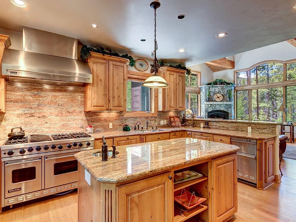 677 White Cloud Drive Breckenridge, CO 80424 - Photo 4 of 25 a kitchen with stainless steel appliances granite countertop a stove a sink and a microwave