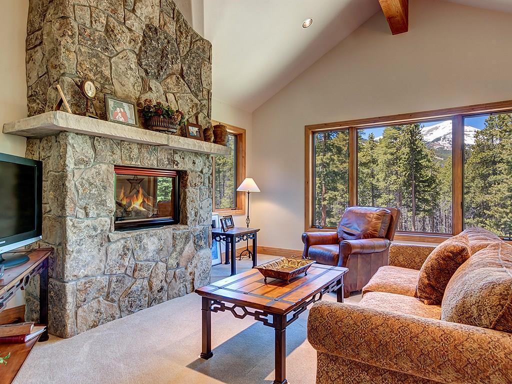677 White Cloud Drive Breckenridge, CO 80424 - Photo 9 of 25 a living room with furniture a flat screen tv and a fireplace