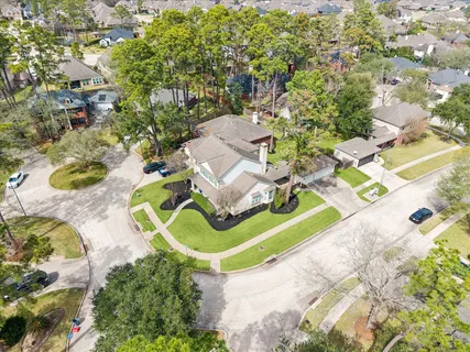 an aerial view of a house with a swimming pool and outdoor space