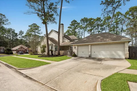 a front view of a house with a yard and trees