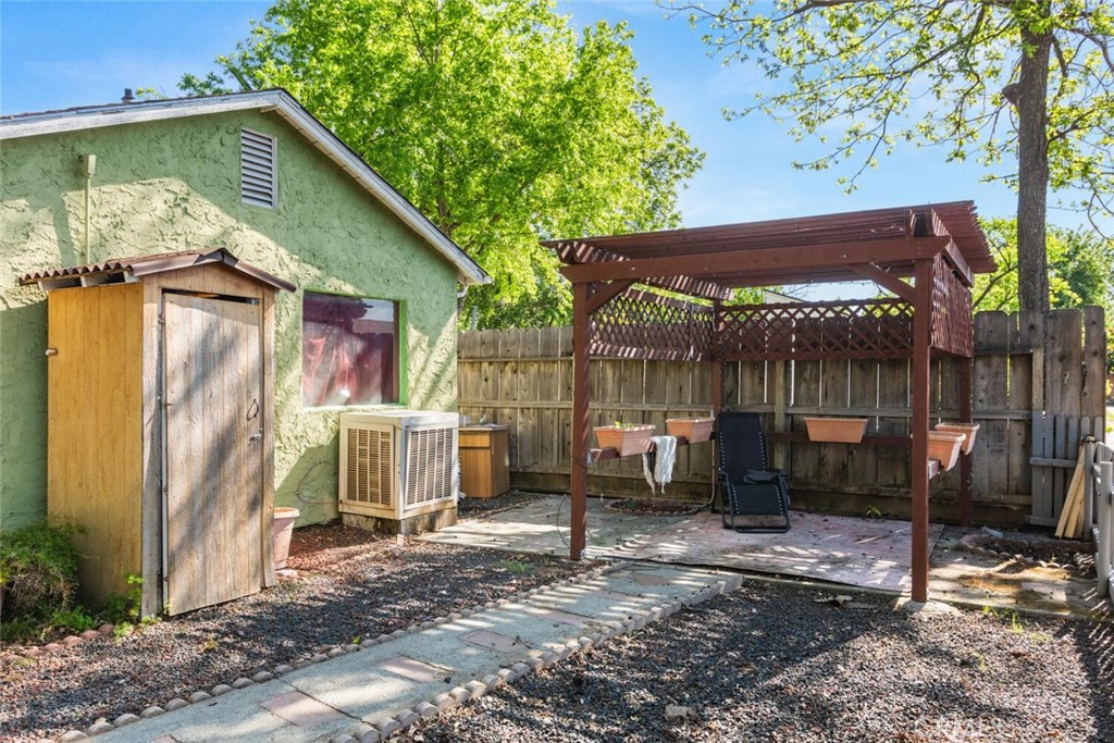 1012 Poppy Street Chico, CA 95928 - Photo 20 of 37 a view of a patio with table and chairs under an umbrella with a small yard