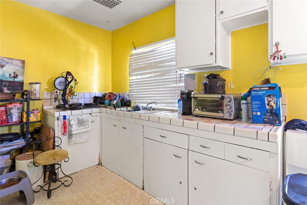 1012 Poppy Street Chico, CA 95928 - Photo 25 of 37 a kitchen with sink cabinets and appliances