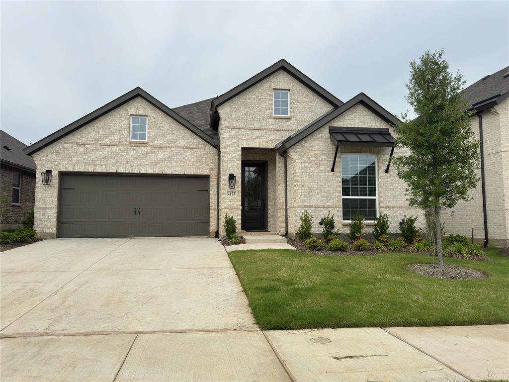 4123 Windy Point Court Oak Point, TX 75068 - Photo 1 of 29 Light-colored brick exterior with dark trim accents
