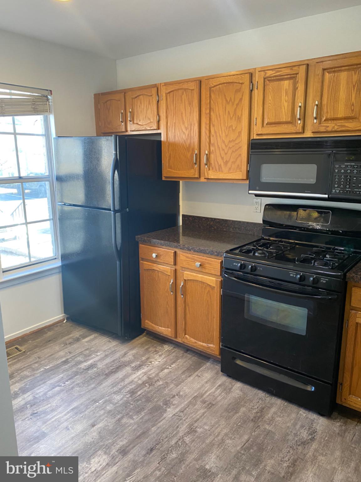 44 Long Green Court Silver Spring, MD 20906 - Photo 15 of 16 Modern kitchen with warm wood accents.