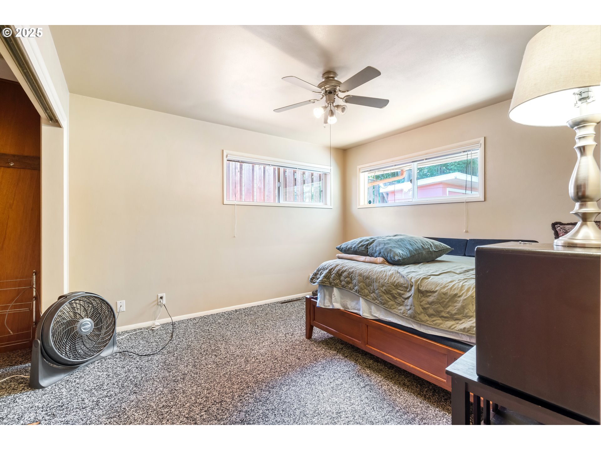 2120 West 23rd Avenue Eugene, OR 97405 - Photo 16 of 35 a bedroom with a bed and a chandelier