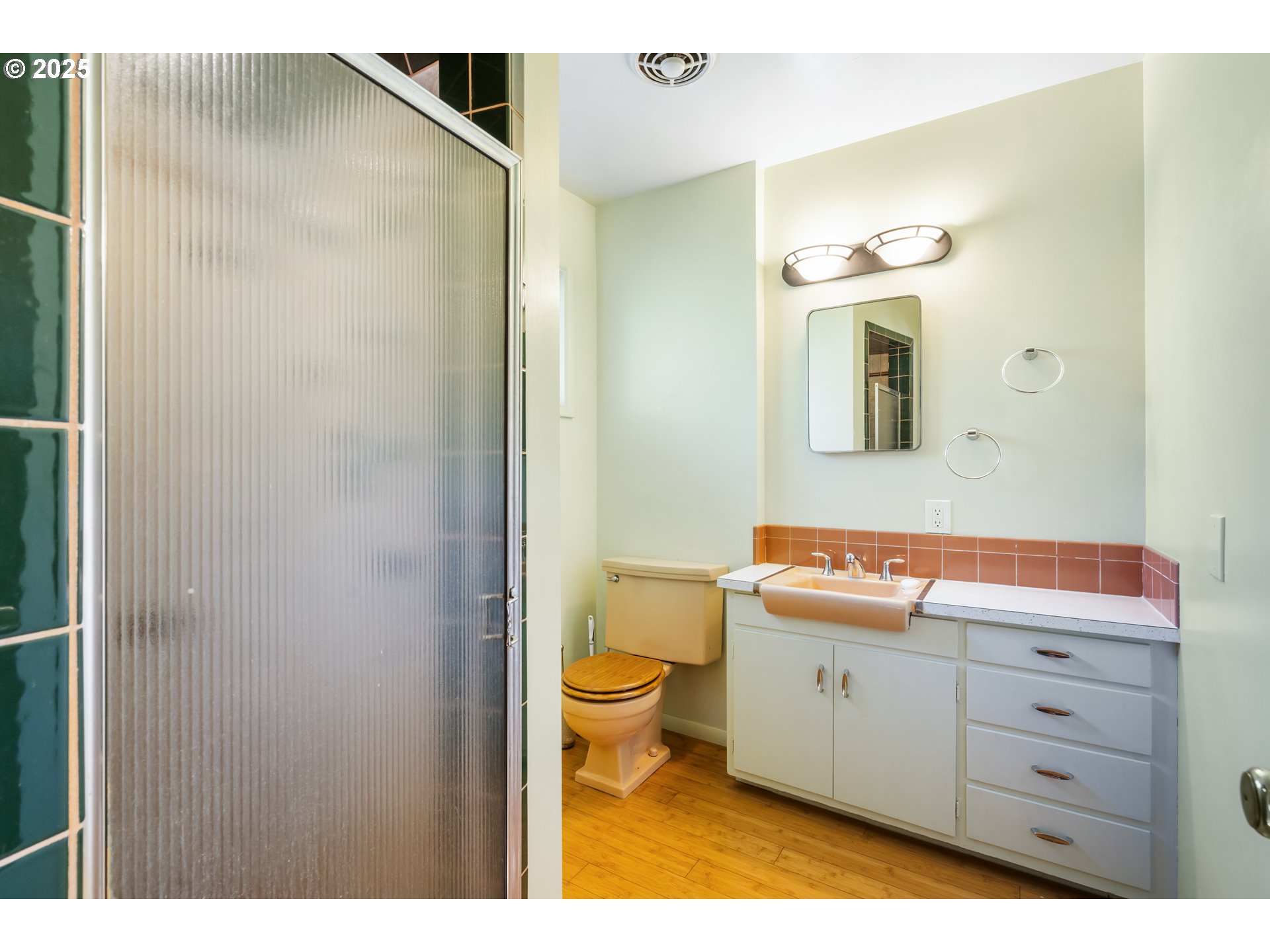 2120 West 23rd Avenue Eugene, OR 97405 - Photo 19 of 35 a bathroom with a sink a toilet and a mirror