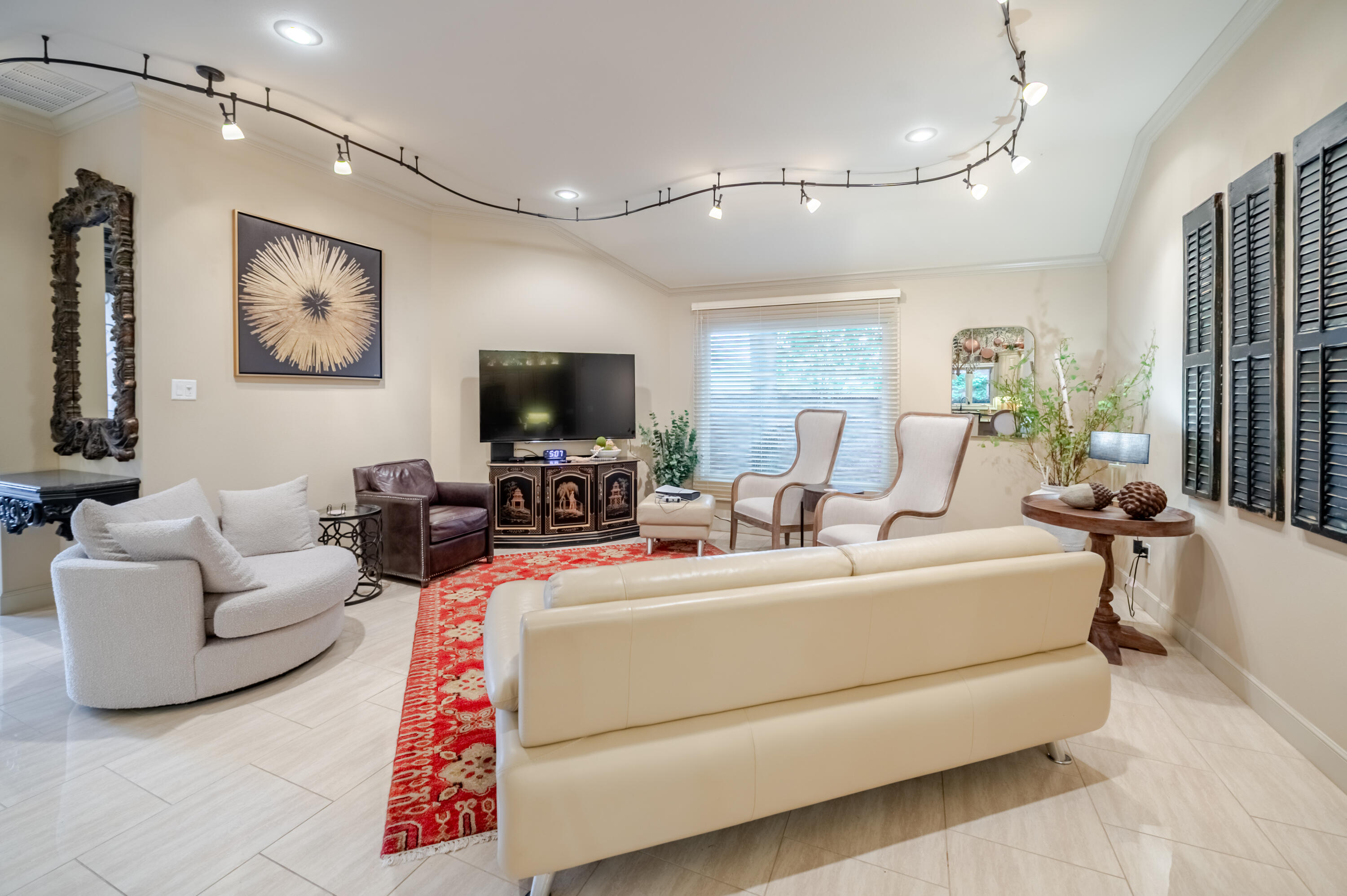 4226 97th Place Lubbock, TX 79423 - Photo 16 of 52 a living room with furniture a flat screen tv and a chandelier