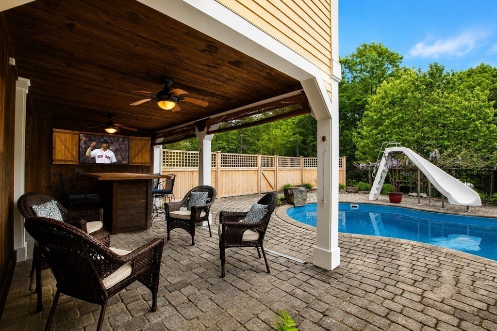 360 Teel Road Winchendon, MA 01475 - Photo 32 of 42 a view of a roof deck with table and chairs with wooden floor and fence