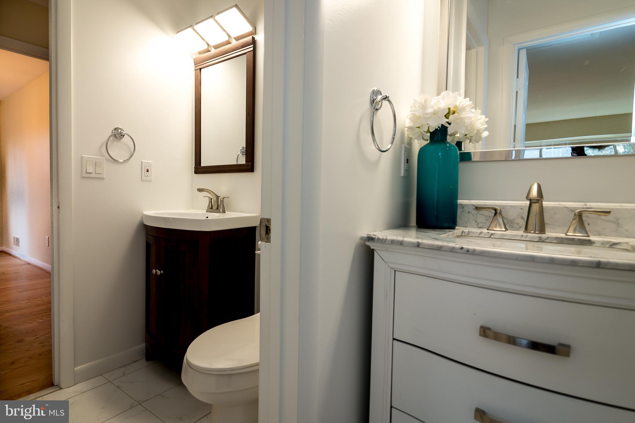 6862 St Albans Road McLean, VA 22101 - Photo 12 of 29 a bathroom with a toilet sink and mirror