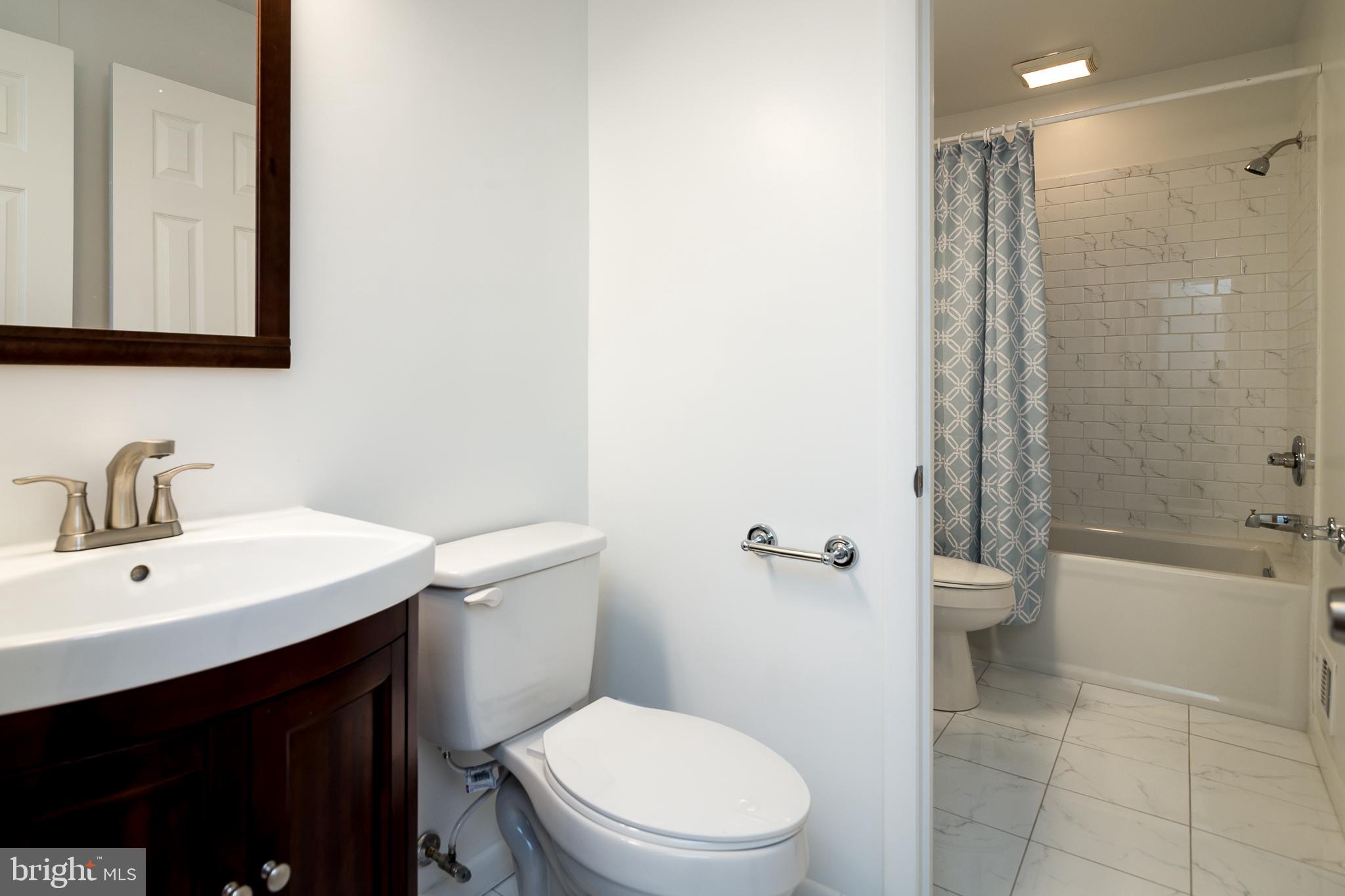 6862 St Albans Road McLean, VA 22101 - Photo 13 of 29 a bathroom with a sink a toilet and shower