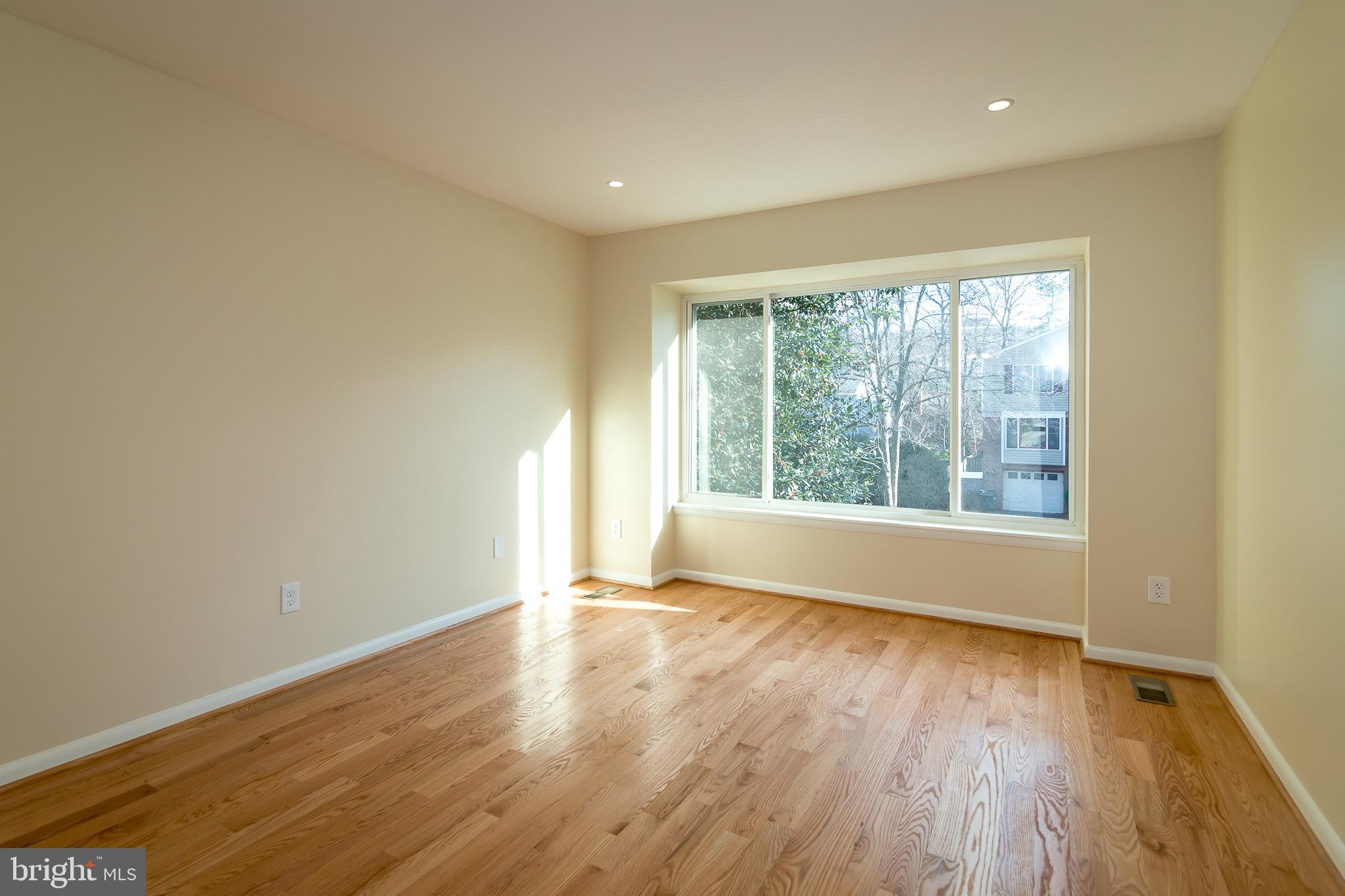 6862 St Albans Road McLean, VA 22101 - Photo 18 of 29 a view of an empty room with wooden floor and a window
