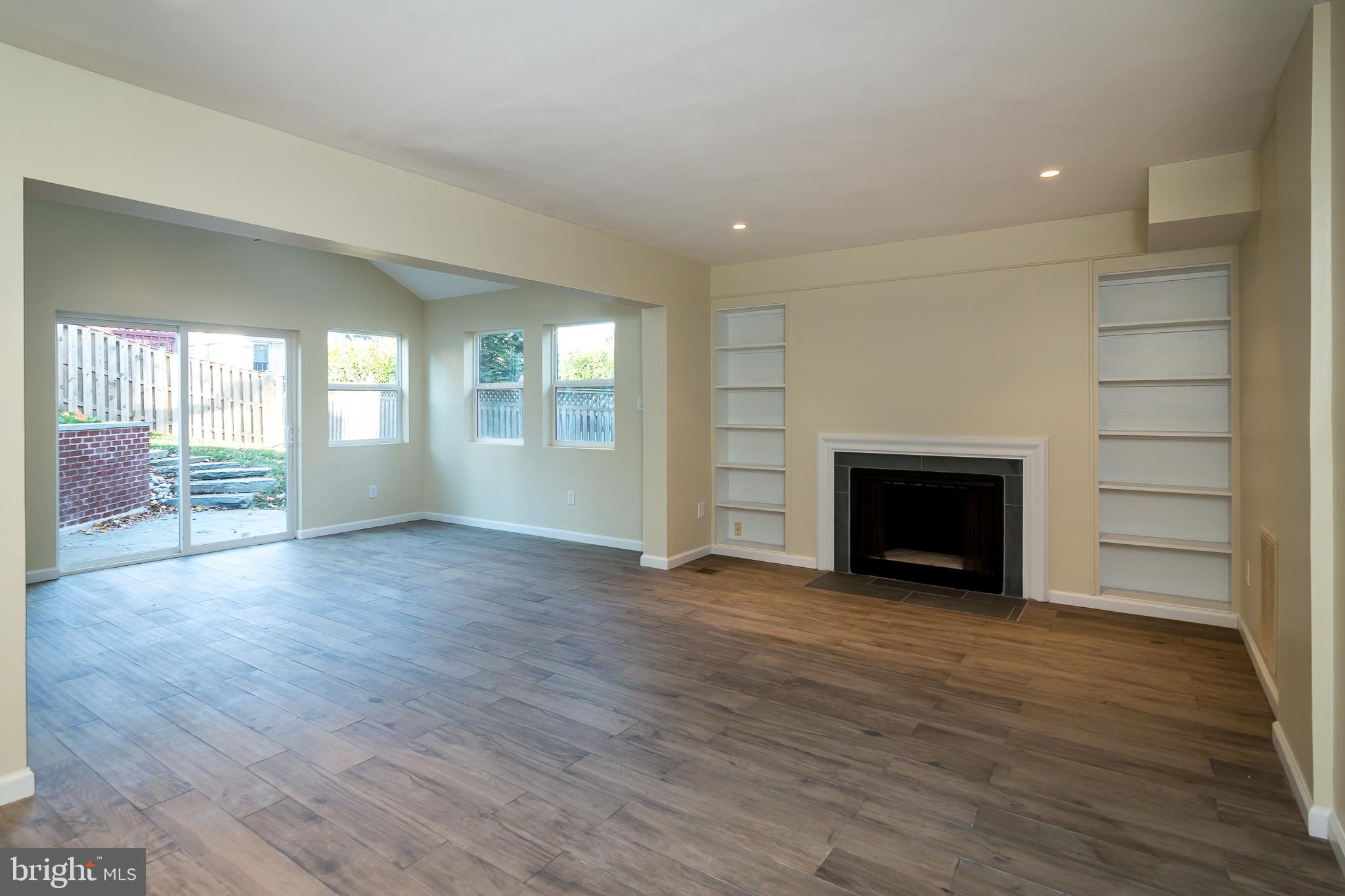 6862 St Albans Road McLean, VA 22101 - Photo 21 of 29 an empty room with wooden floor and fireplace