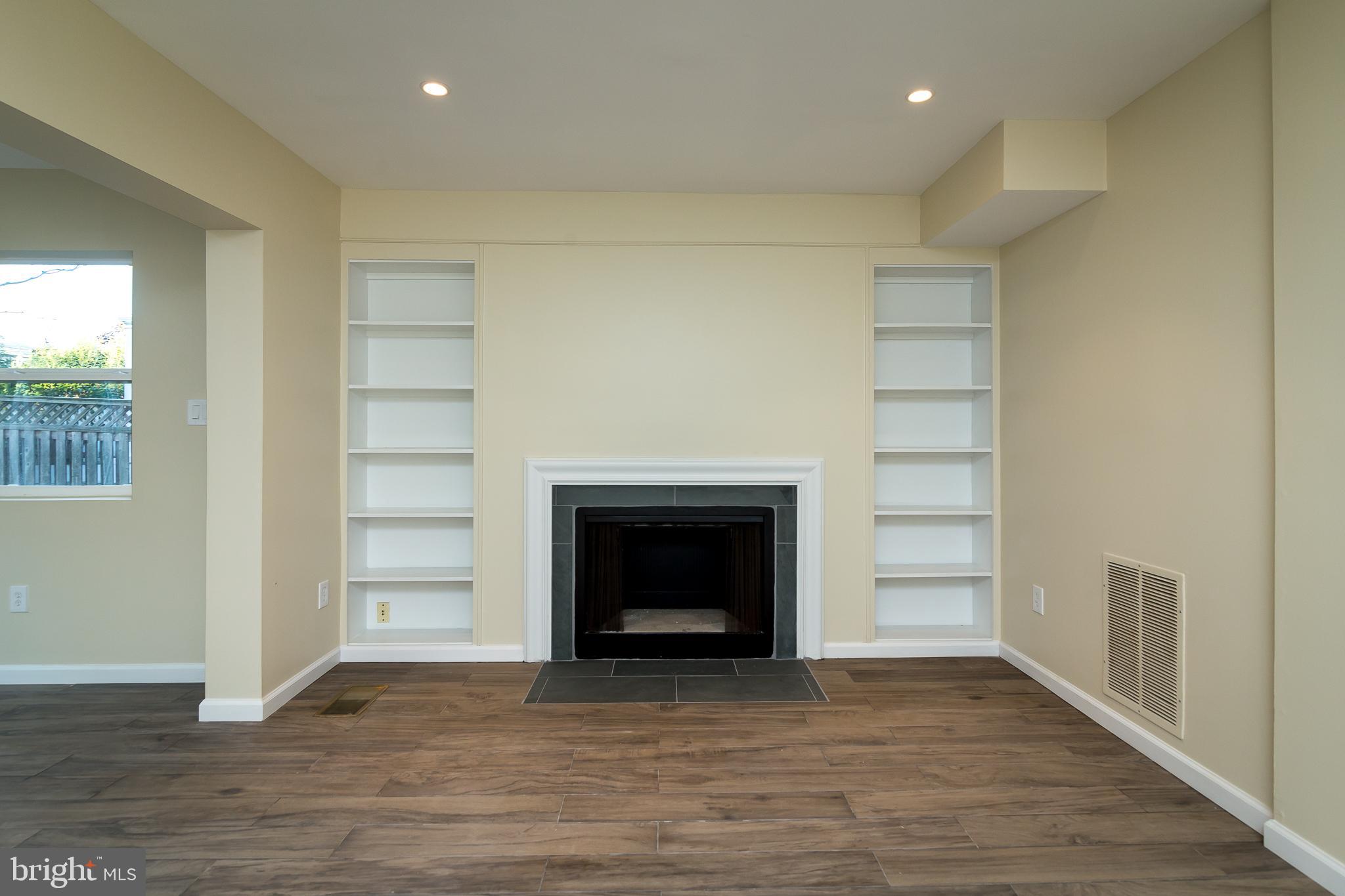 6862 St Albans Road McLean, VA 22101 - Photo 22 of 29 an empty room with wooden floor fireplace and windows