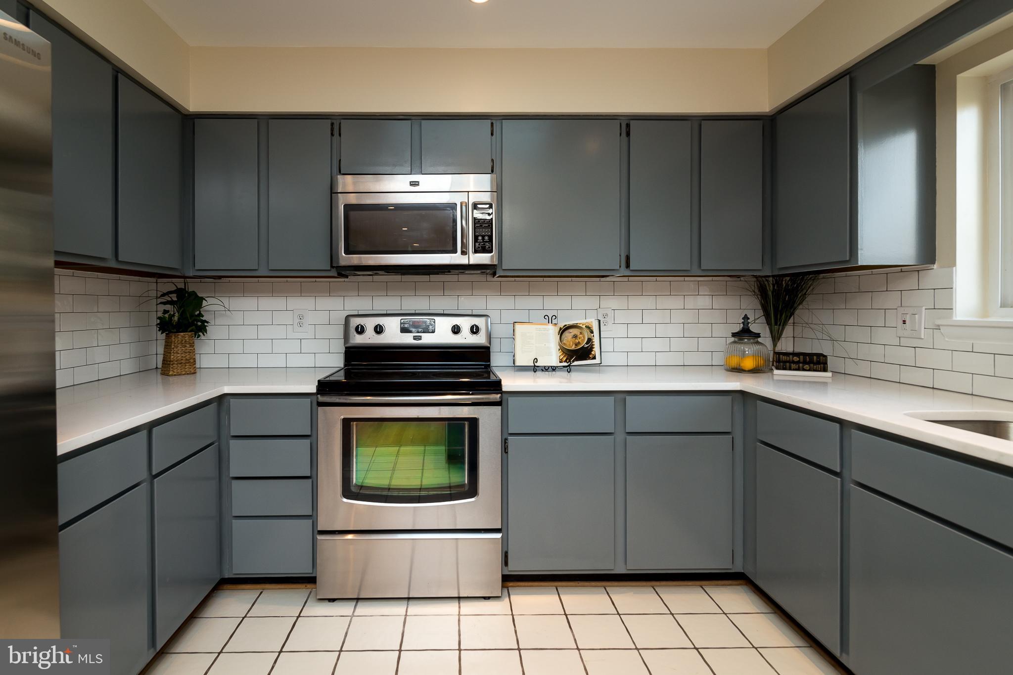 6862 St Albans Road McLean, VA 22101 - Photo 3 of 29 a kitchen with a sink a stove and cabinets