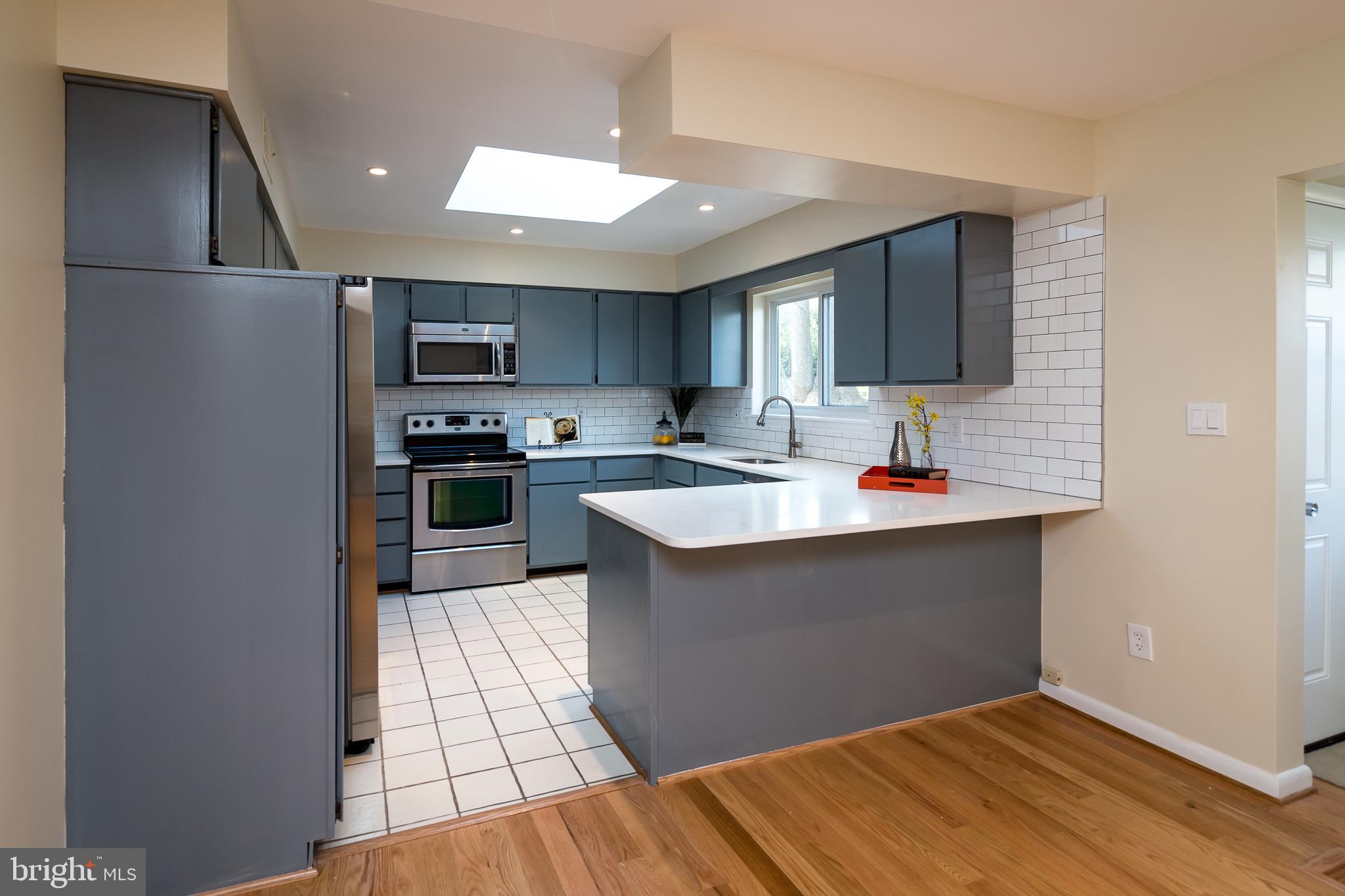 6862 St Albans Road McLean, VA 22101 - Photo 4 of 29 a kitchen with stainless steel appliances granite countertop a sink stove and refrigerator