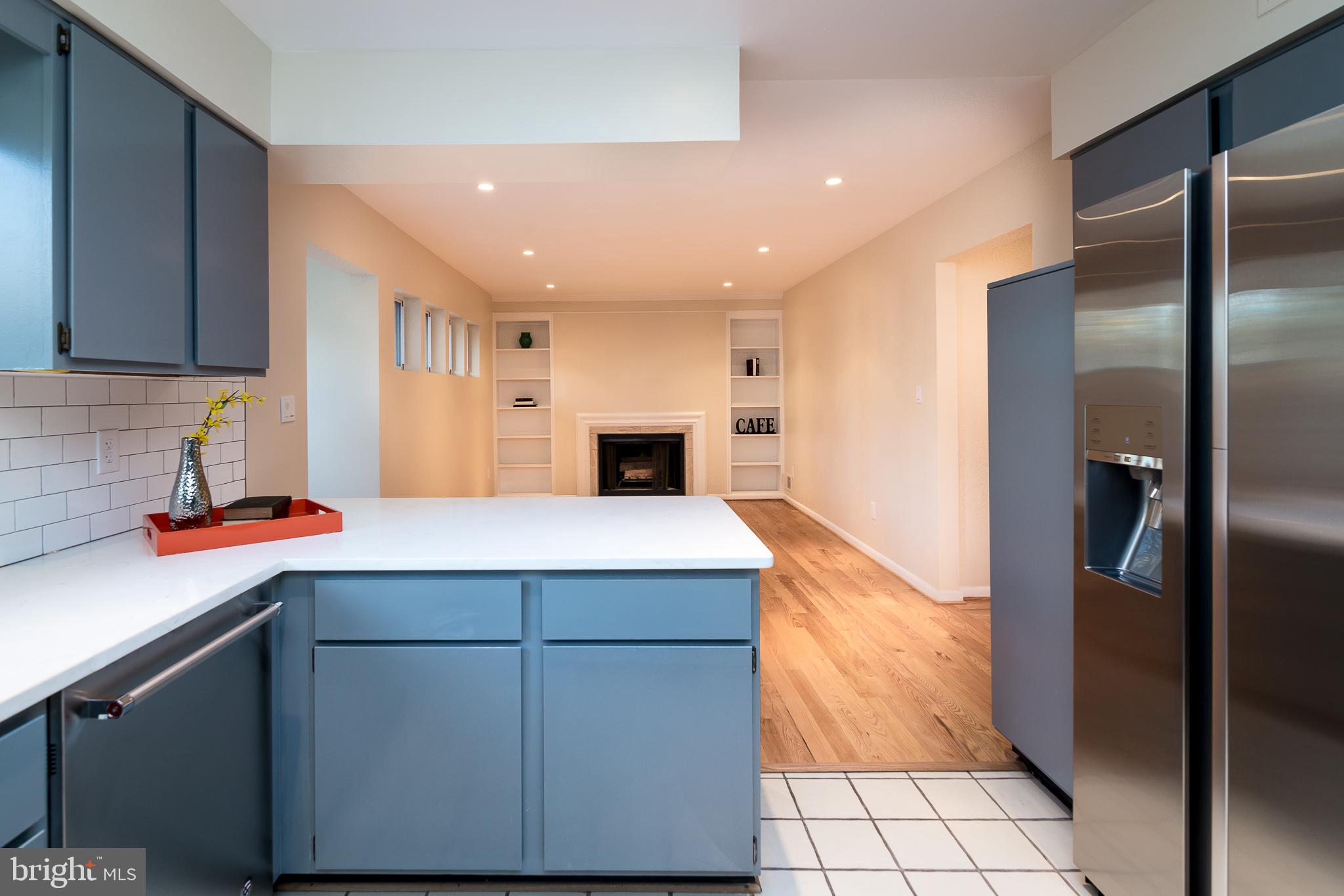 6862 St Albans Road McLean, VA 22101 - Photo 5 of 29 a living room with stainless steel appliances kitchen island granite countertop a refrigerator a sink and a stove