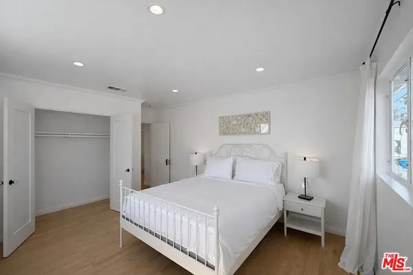 a bedroom with a bed and a night stand