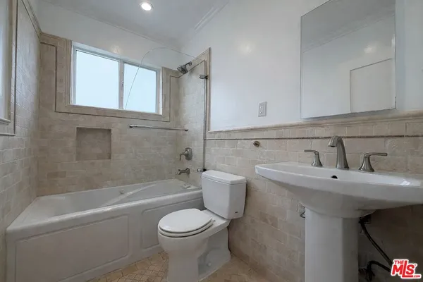 a bathroom with a sink a toilet and bathtub