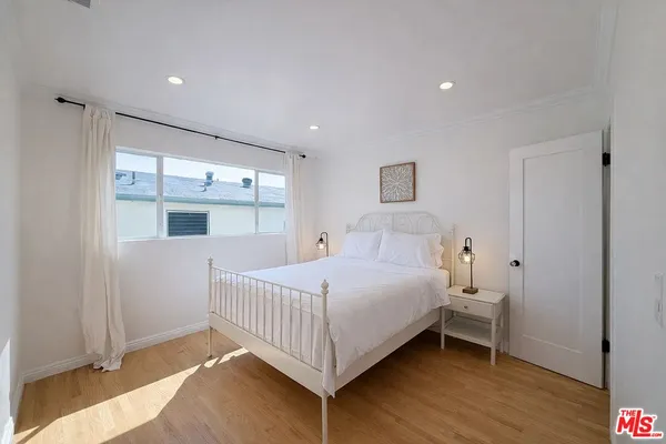 a bedroom with a bed and window