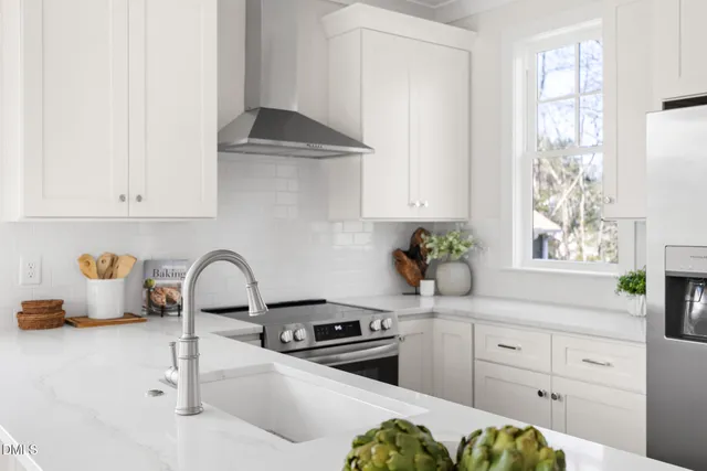 a kitchen with a sink cabinets and appliances