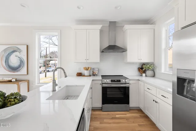 a kitchen with a stove sink and cabinets