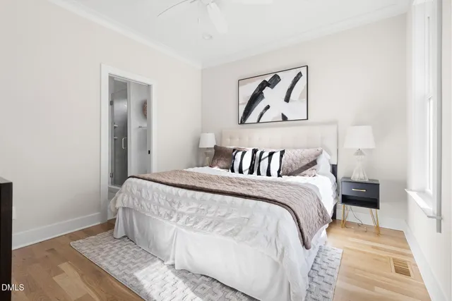 a bed room with a bed and a painting on the wall