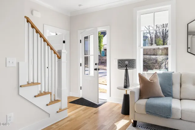 a living room with furniture and large windows