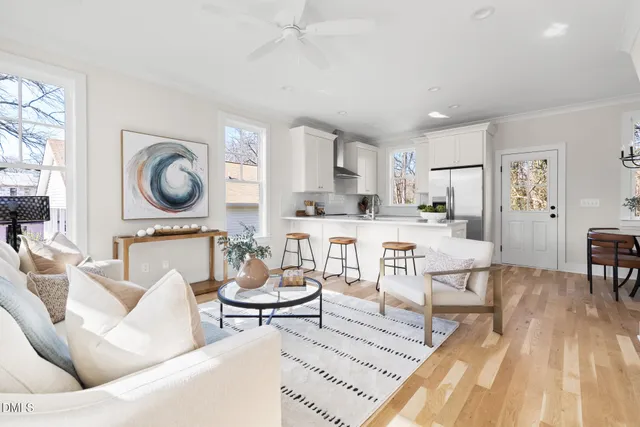 a living room with furniture and a wooden floor