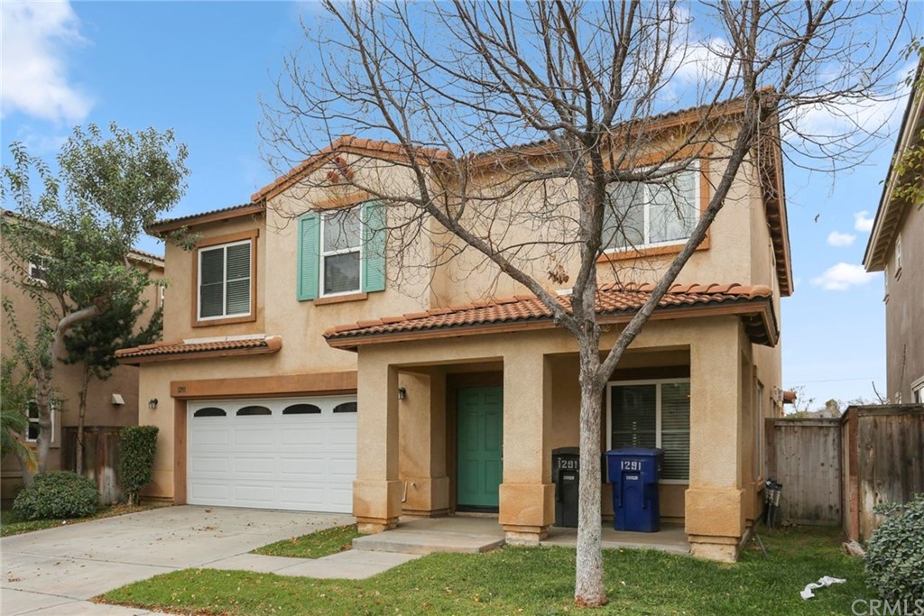 1291 Castledale Street Riverside, CA 92501 - Photo 1 of 1 a front view of a house with a yard and garage