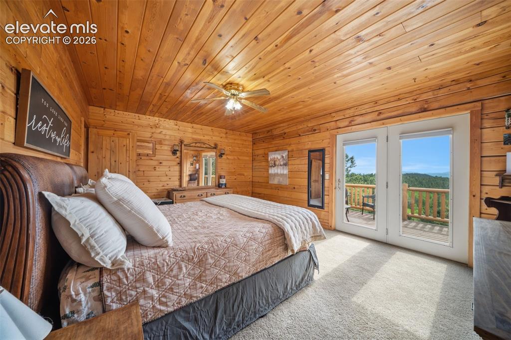 4269 Cedar Mountain Road Divide, CO 80814 - Photo 11 of 39 Main level primary bedroom with walk out to back deck and the view are stunning
