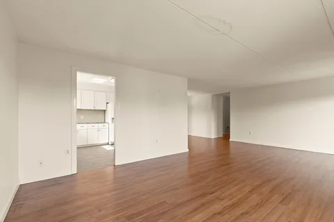 a kitchen with white cabinets and refrigerator
