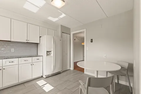 a view of an empty room and wooden floor