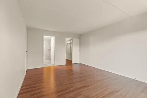 a view of a room with wooden floor