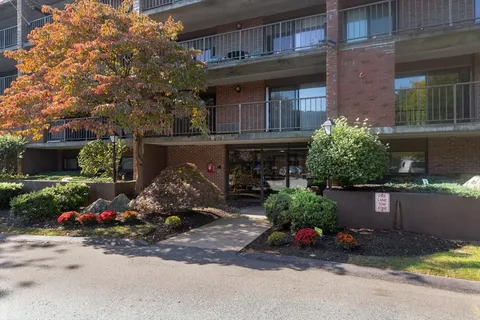 a front view of a house with a yard and a garage