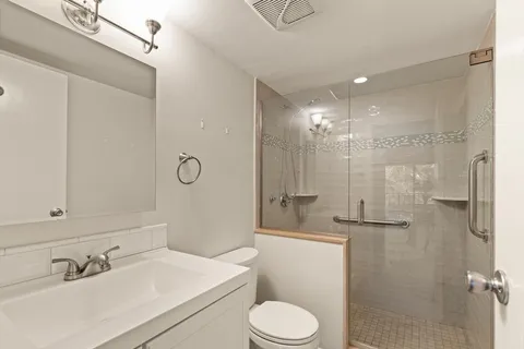 a bathroom with a sink toilet tub and shower