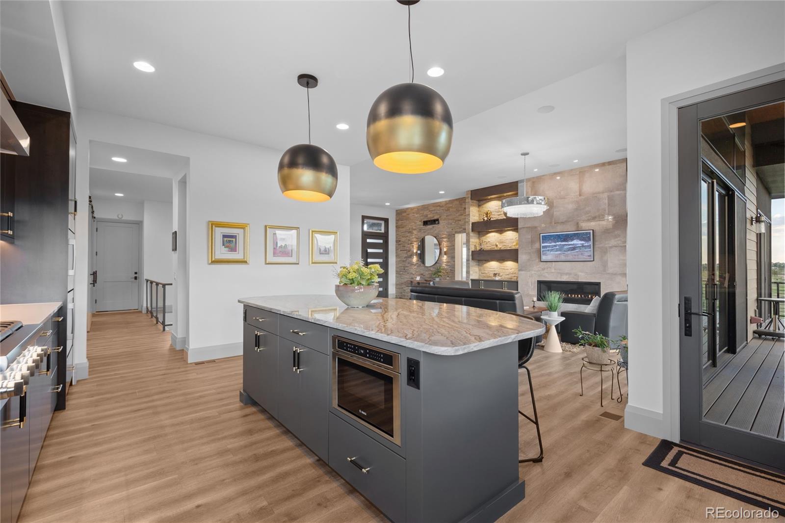 10689 Shadow Pines Road Parker, CO 80138 - Photo 13 of 50 a kitchen with a stove and a wooden floor