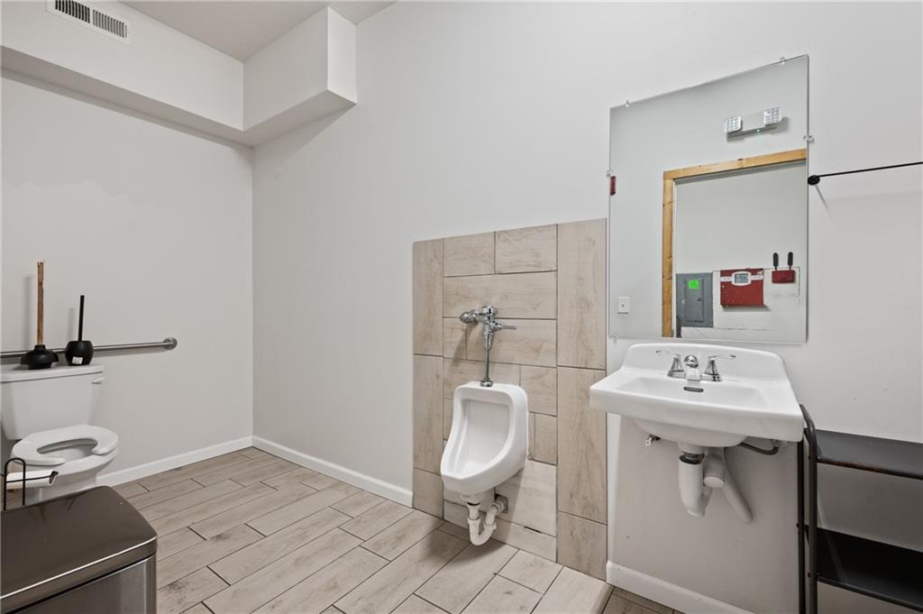 200 East 8th Avenue Homestead, PA 15120 - Photo 13 of 50 a bathroom with a sink toilet and a mirror