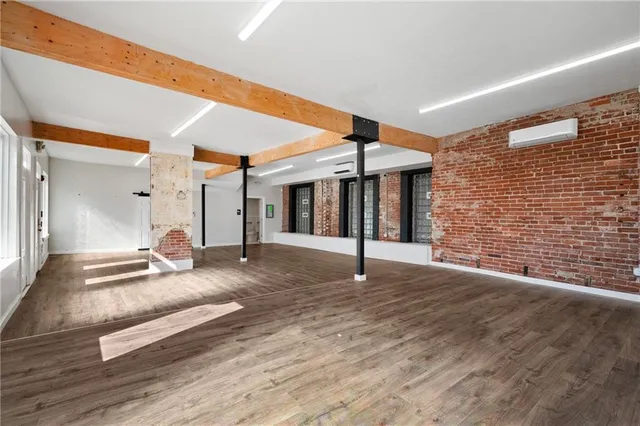 a view of a kitchen with wooden floor and electronic appliances