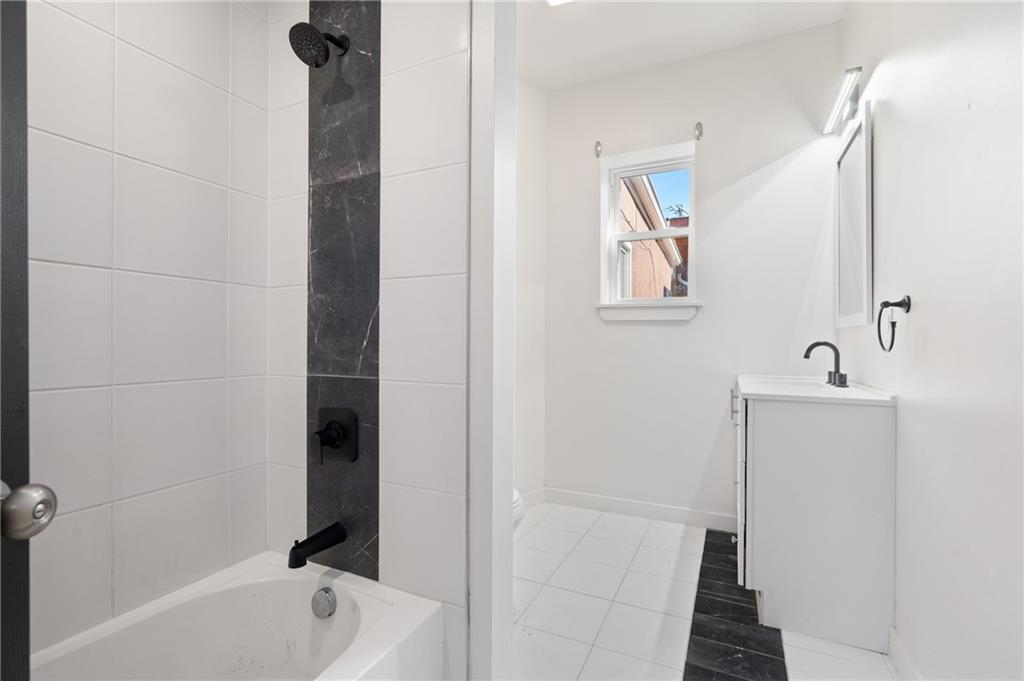 200 East 8th Avenue Homestead, PA 15120 - Photo 34 of 50 a bathroom with a tub sink and mirror
