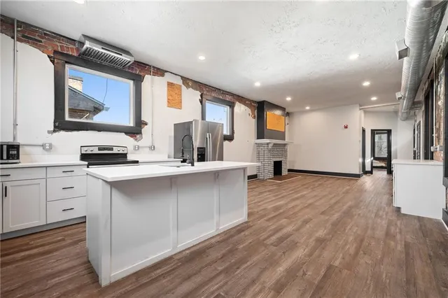 a view of kitchen with cabinets and wooden floor
