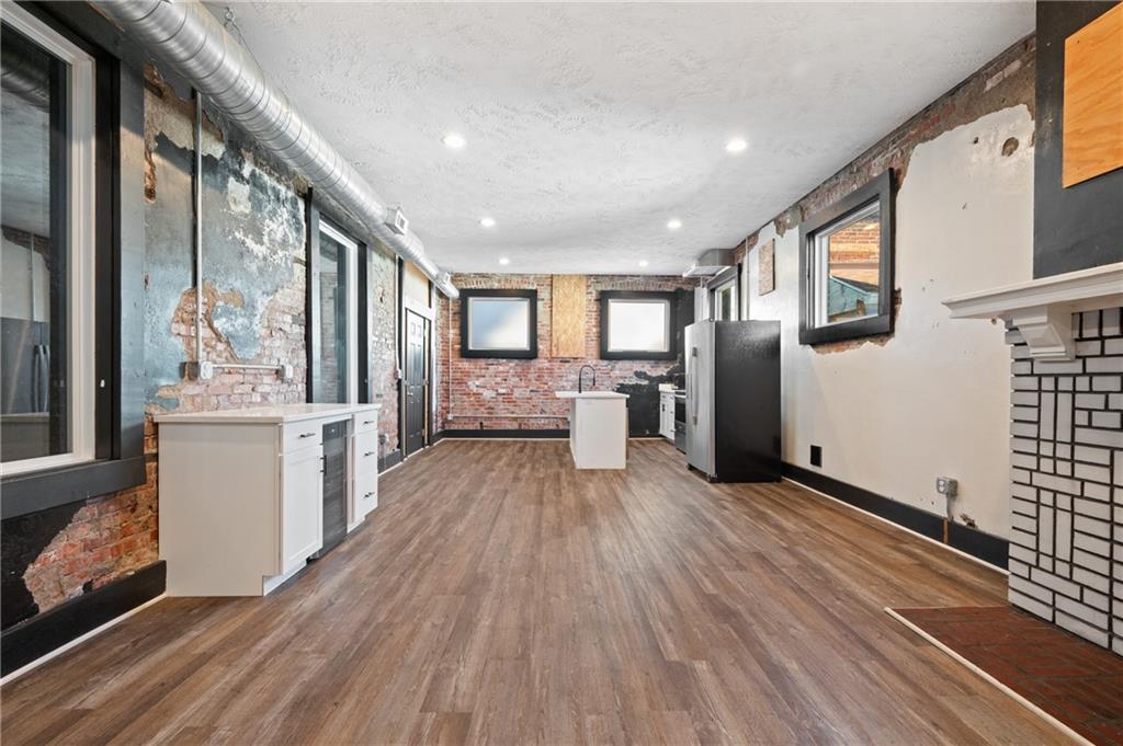 200 East 8th Avenue Homestead, PA 15120 - Photo 45 of 50 a view of a kitchen with a refrigerator cabinets and wooden floor