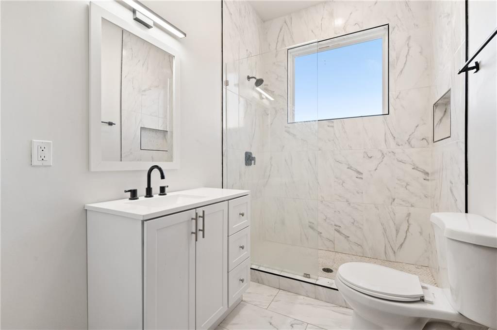 200 East 8th Avenue Homestead, PA 15120 - Photo 46 of 50 a white toilet sitting next to a bathroom sink