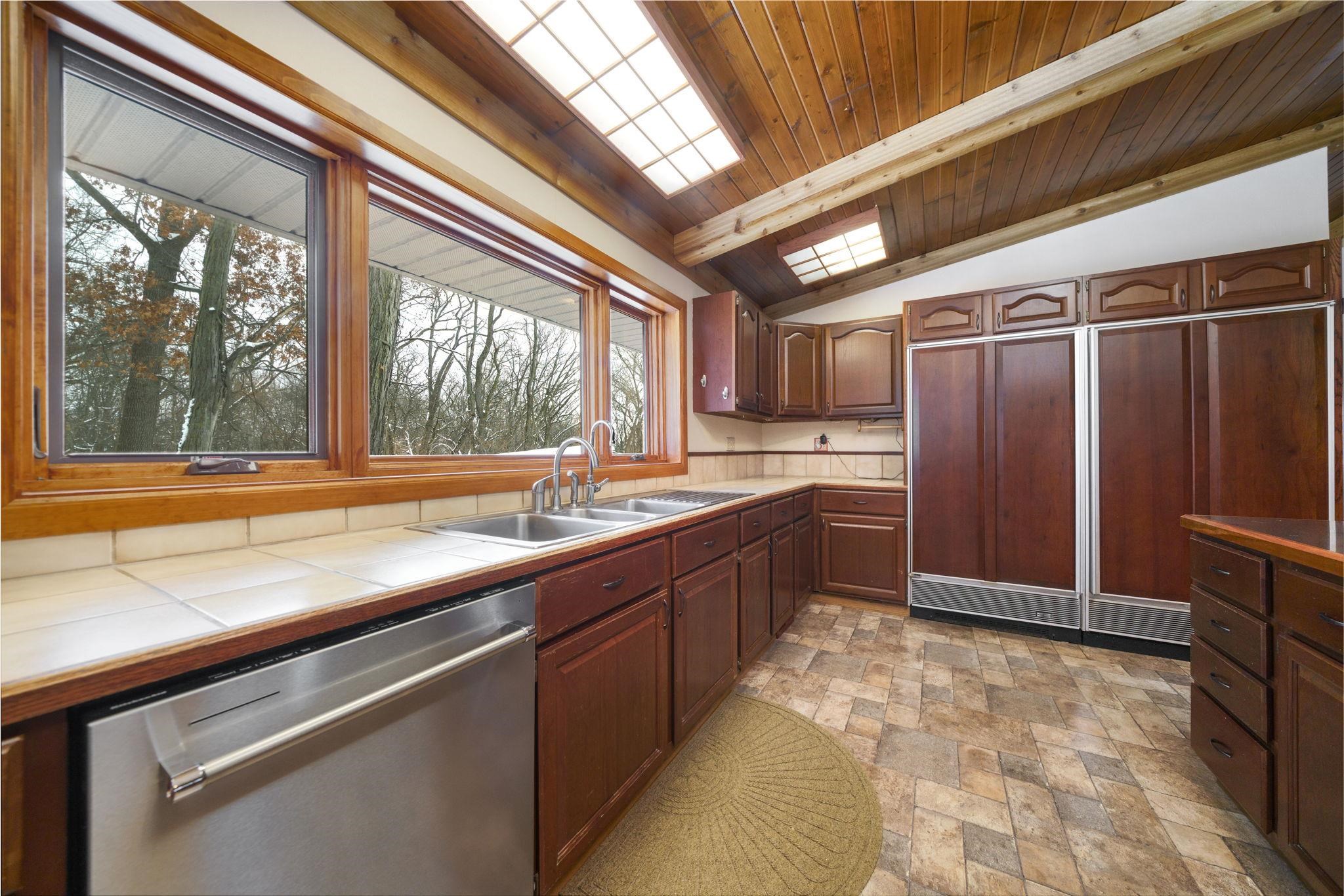 1203 West Mud Creek Road Oregon, IL 61061 - Photo 13 of 67 a large kitchen with a large window cabinets and stainless steel appliances