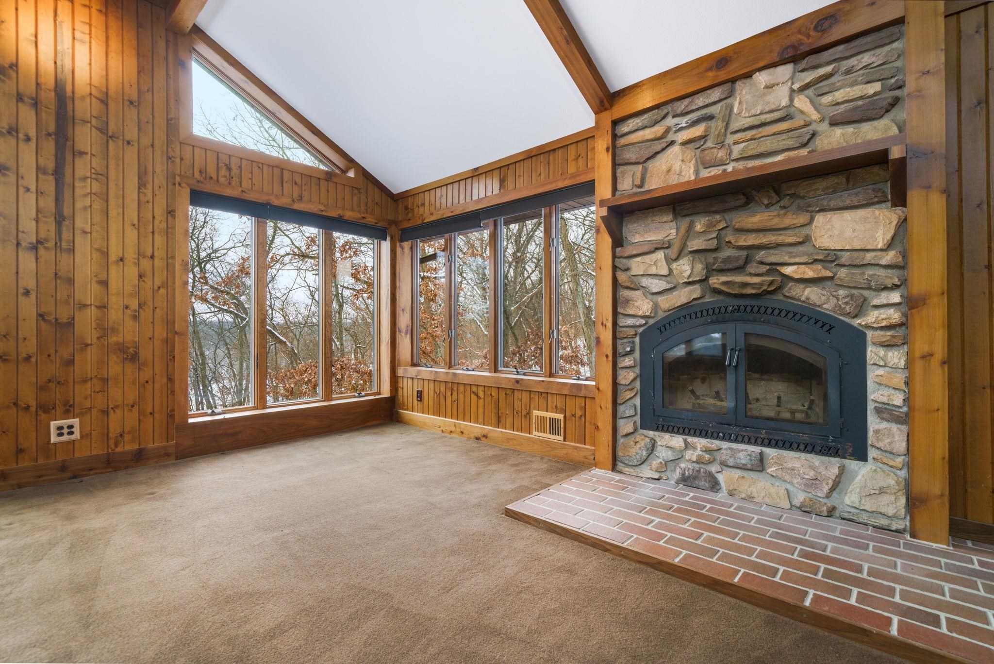 1203 West Mud Creek Road Oregon, IL 61061 - Photo 20 of 67 a living room with a fireplace furniture and a large window
